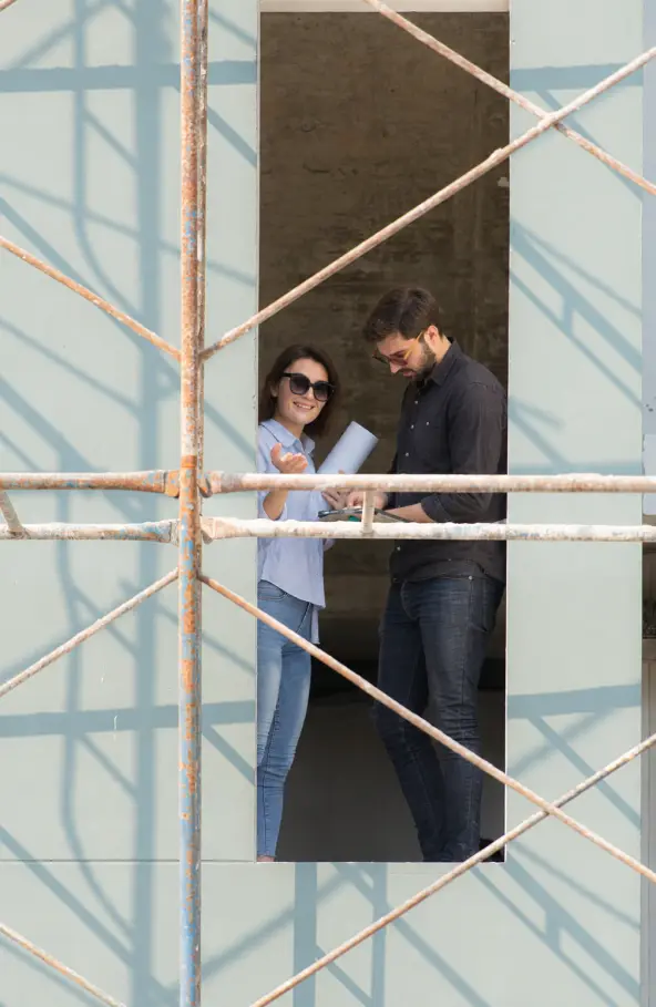 Engineer inspecting weathered exterior siding